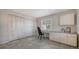 Home office with built-in desk, lots of storage, and large windows; adjacent to large closet at 5458 Golf Pointe Dr, Sarasota, FL 34243
