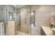 Bathroom shower with glass door, waterfall shower head, and decorative alcove at 5458 Golf Pointe Dr, Sarasota, FL 34243