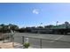 Well-maintained tennis court at the Palm-Aire Racquet Club, ready for competitive play under a sunny sky at 5458 Golf Pointe Dr, Sarasota, FL 34243