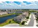 Aerial view of a community showcasing townhomes, lush landscaping, and scenic ponds at 5543 Pleasantview Ct, Bradenton, FL 34211