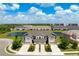 Aerial view of townhomes, featuring well-maintained landscaping and a serene pond at 5543 Pleasantview Ct, Bradenton, FL 34211