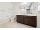 Modern bathroom featuring a dark wood vanity, white countertop, and a large, framed mirror at 5543 Pleasantview Ct, Bradenton, FL 34211