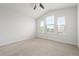 Sunlit bedroom featuring vaulted ceiling, plush carpeting, and three large windows with blinds at 5543 Pleasantview Ct, Bradenton, FL 34211