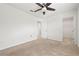 Spacious bedroom featuring neutral carpet, ceiling fan, closet, and an open doorway to the hallway at 5543 Pleasantview Ct, Bradenton, FL 34211