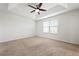 Bright bedroom with neutral carpet, a ceiling fan, and a large window providing ample natural light at 5543 Pleasantview Ct, Bradenton, FL 34211