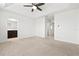 Spacious bedroom with neutral carpet, tray ceiling with fan, and an en-suite bathroom at 5543 Pleasantview Ct, Bradenton, FL 34211