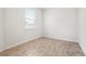 Bright bedroom features wood-look tile flooring and natural light from the window at 5543 Pleasantview Ct, Bradenton, FL 34211