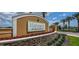 A community welcome sign surrounded by landscaped flower beds, shrubbery and palm trees at 5543 Pleasantview Ct, Bradenton, FL 34211
