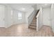 Bright entryway featuring wood-look flooring and a carpeted staircase at 5543 Pleasantview Ct, Bradenton, FL 34211