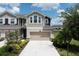 Townhome exterior with a two-car garage and manicured landscaping at 5543 Pleasantview Ct, Bradenton, FL 34211