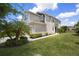 Charming two-story home with a well-manicured lawn and lush landscaping at 5543 Pleasantview Ct, Bradenton, FL 34211