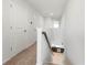 Bright hallway with carpet runner, white walls and trim, and view of the stairwell wet bar at 5543 Pleasantview Ct, Bradenton, FL 34211