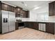 Modern kitchen with stainless steel appliances and dark cabinetry at 5543 Pleasantview Ct, Bradenton, FL 34211