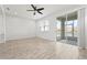 Spacious living area boasts wood-look tile, ceiling fan, and sliding door access to the lanai at 5543 Pleasantview Ct, Bradenton, FL 34211
