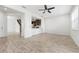 Inviting living room flows into the open kitchen, featuring wood-look tile flooring and staircase at 5543 Pleasantview Ct, Bradenton, FL 34211