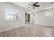 Bright bedroom features wood-look tile flooring, fan, and sliding door access to the lanai at 5543 Pleasantview Ct, Bradenton, FL 34211