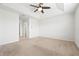 Spacious bedroom featuring a ceiling fan, tray ceiling, neutral paint, and carpet at 5543 Pleasantview Ct, Bradenton, FL 34211