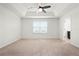 Spacious main bedroom with a tray ceiling, fan, and an ensuite bathroom at 5543 Pleasantview Ct, Bradenton, FL 34211
