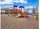 Community playground with slides, climbing structures, and a wood chip ground cover at 5543 Pleasantview Ct, Bradenton, FL 34211