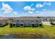 Beautiful rear exterior view of townhomes with green lawns and screened patios by a pond at 5543 Pleasantview Ct, Bradenton, FL 34211