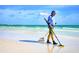 Beautiful Gulf Coast beach scene with a Personal using a metal detector on a sunny day at 5663 Midnight Pass Rd # 407, Sarasota, FL 34242