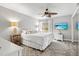 Comfortable bedroom with a ceiling fan, window, television, and neutral decor creating a relaxing space at 5663 Midnight Pass Rd # 407, Sarasota, FL 34242