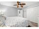 Cozy bedroom featuring a ceiling fan, closet, and a comfortable bed with patterned bedding at 5663 Midnight Pass Rd # 407, Sarasota, FL 34242