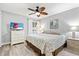 Bright bedroom offering a ceiling fan, television, and large windows providing ample natural light at 5663 Midnight Pass Rd # 407, Sarasota, FL 34242