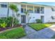 Well-maintained condo building featuring lush landscaping and a welcoming entrance at 5663 Midnight Pass Rd # 407, Sarasota, FL 34242