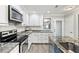 This kitchen features ample counter space, white cabinetry, and updated appliances at 5663 Midnight Pass Rd # 407, Sarasota, FL 34242