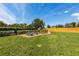 Backyard featuring garden beds, mature trees, green lawn, and a privacy fence at 5704 2Nd Avenue Nw Dr, Bradenton, FL 34209