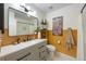 Stylish bathroom with terrazzo floors, modern vanity, and unique wall decor at 5704 2Nd Avenue Nw Dr, Bradenton, FL 34209