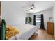 Bright bedroom featuring wood floors, a ceiling fan, and a sunny window at 5704 2Nd Avenue Nw Dr, Bradenton, FL 34209