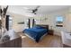 Bright bedroom featuring wood floors, a ceiling fan, and bright light from the windows at 5704 2Nd Avenue Nw Dr, Bradenton, FL 34209
