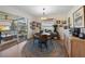 Bright dining area features a round table, chandelier lighting, and sliding glass doors to an outdoor patio space at 5704 2Nd Avenue Nw Dr, Bradenton, FL 34209