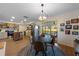 Eat-in kitchen with a round dining table, pendant lighting, and stainless-steel appliances creates an inviting atmosphere at 5704 2Nd Avenue Nw Dr, Bradenton, FL 34209