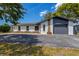 Gorgeous renovated house featuring an attached garage, stylish architectural accents, and a well-manicured lawn at 5704 2Nd Avenue Nw Dr, Bradenton, FL 34209