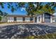 Beautifully renovated house featuring modern exterior design, a well-maintained lawn, and an attached garage at 5704 2Nd Avenue Nw Dr, Bradenton, FL 34209