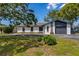 Charming single-story house featuring a well-kept lawn, stylish accents, and a convenient attached garage at 5704 2Nd Avenue Nw Dr, Bradenton, FL 34209