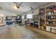 Spacious garage with ample storage shelves, workbench, and room for vehicles at 5704 2Nd Avenue Nw Dr, Bradenton, FL 34209