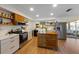 Open kitchen design with stainless steel appliances, an island, and a window view at 5704 2Nd Avenue Nw Dr, Bradenton, FL 34209