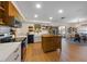 Gourmet kitchen featuring stainless steel appliances, an island, and open layout at 5704 2Nd Avenue Nw Dr, Bradenton, FL 34209