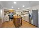 Bright kitchen with stainless appliances, a center island, and a farmhouse sink at 5704 2Nd Avenue Nw Dr, Bradenton, FL 34209