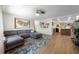 Open-concept living room featuring a stylish gray sectional sofa and hardwood floors at 5704 2Nd Avenue Nw Dr, Bradenton, FL 34209