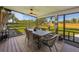 Spacious outdoor porch features a ceiling fan, stylish dining table, and backyard views, perfect for entertaining at 5704 2Nd Avenue Nw Dr, Bradenton, FL 34209