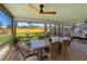 Inviting outdoor porch features dining furniture, ceiling fan, and views of the spacious yard perfect for dining or relaxing at 5704 2Nd Avenue Nw Dr, Bradenton, FL 34209