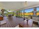 Relaxing outdoor porch with beautiful green lawn views through screened windows, ideal for outdoor gatherings and relaxation at 5704 2Nd Avenue Nw Dr, Bradenton, FL 34209