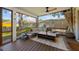 Cozy outdoor porch features comfortable seating, wood flooring and views of the fenced yard, creating a relaxing retreat at 5704 2Nd Avenue Nw Dr, Bradenton, FL 34209