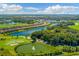 Scenic aerial view of the community featuring homes, lakes, golf course, and lush landscaping at 5810 Brandon Run, Bradenton, FL 34211