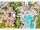Overhead view showcasing community clubhouse with a resort-style pool, lush landscaping and well manicured green spaces at 5810 Brandon Run, Bradenton, FL 34211